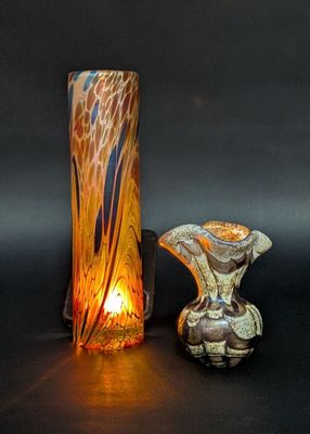 two vases sitting next to each other on a table