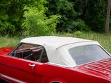 a red and white car parked on the side of the road