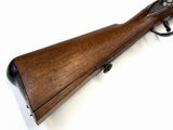 a rifle with a wooden barrel on a white background