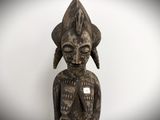 a close up of a statue of a person with a hat on
