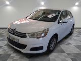 the white car is parked on the checkered floor in the showroom