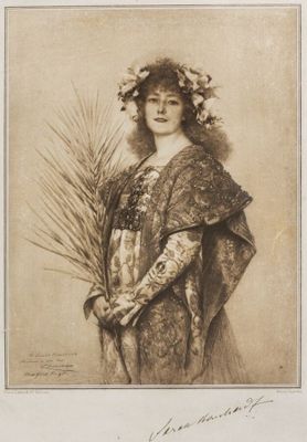 an old picture of a woman holding a plant in her hand