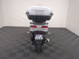 a motorcycle that is sitting on a black and white checkered floor