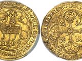 a gold coin with an image of a goat on it