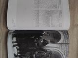 an open book with a picture of a group of people standing in front of a building