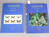 pair of two books with butterflies on them sitting on a table