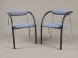 two blue chairs with chrome legs and a blue seat