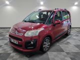 the red citrole is parked on a checkered tile floor