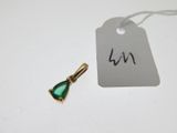 un petit pendentif vert en forme de larme auquel est attachée une étiquette