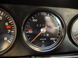 three speedometers on the dashboard of a car