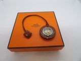 an orange box with a watch inside of it on a white surface