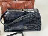 two purses that are sitting next to each other