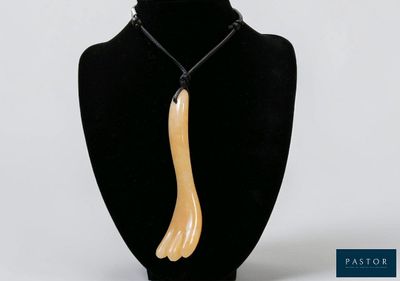 a close up of a necklace on a mannequin neck