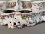 a close up of a tea set with cups and saucers