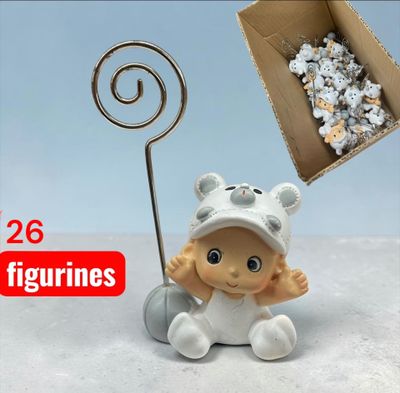 a small figurine of a baby in a white outfit