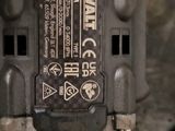 a close up of a power drill on a table