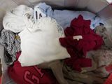 a basket full of clothes that is sitting on the floor