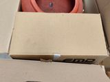 a box with a red object in it and a red object in it
