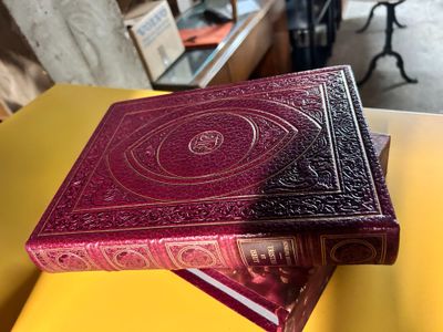two books sitting on top of each other on a yellow table