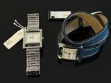 a watch and a bracelet on a black table