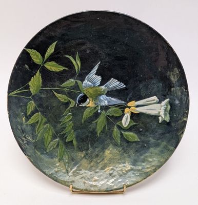 a painting of a bird on a plate with flowers on it