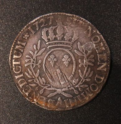 an old coin with a crown on top of it on a table