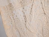 a close up of a white dress with a paisley pattern on it