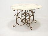 wrought iron table with a marble top and scrolled legs