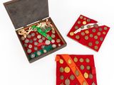 a box with coins and a red cloth on the table