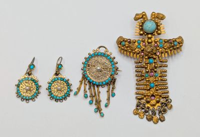 a close up of a group of jewelry on a white surface