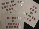four sheets of paper with stamps on them sitting on a table