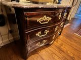 a marble top chest of drawers in a living room
