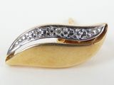 a close up of a gold and diamond broochle