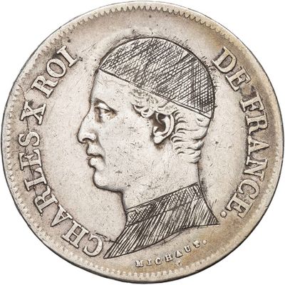 Gros plan sur une pièce de monnaie avec le dessin d'une tête d'homme