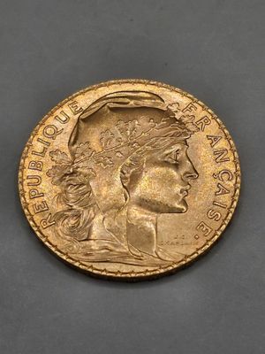 a gold coin with a woman ' s head on it