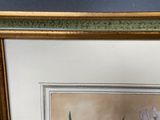 painting of a white flower in a gold frame on a blue wall