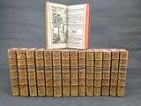 an open book sitting on top of a stack of old books