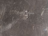 a close up of a metal plate with a metal handle