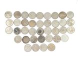 many different types of coins arranged together on a white surface
