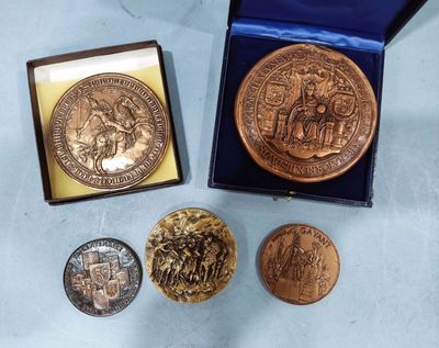 several coins are sitting in a blue box on a table