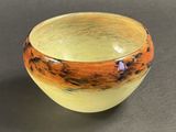 a yellow and orange bowl sitting on a table