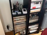 a book shelf that has a bunch of cds on it