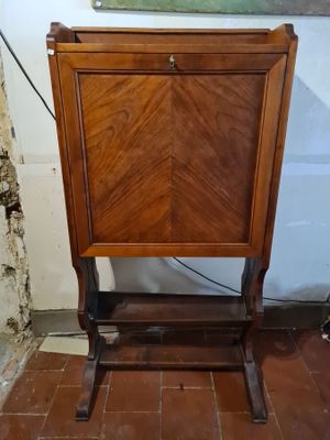 a small wooden cabinet with a door on top of it