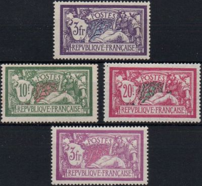 four different colored stamps on a black surface