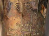 a silver vase with a picture of a ship on it
