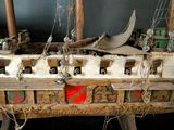 a wooden model of a boat with a lot of stuff on it