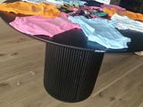 a table that has a lot of t - shirts on it