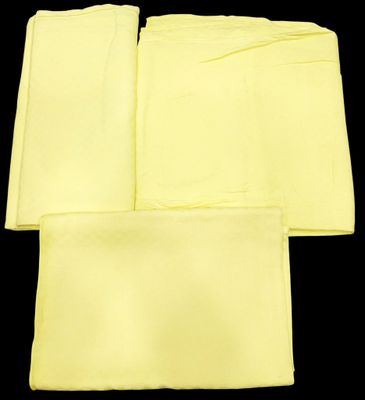 four yellow napkins on a black background with a black background