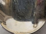 a silver spoon with a handle on a table