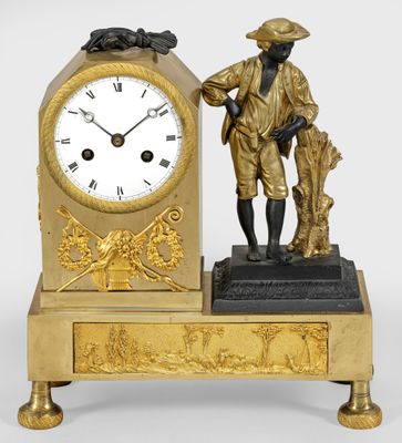 a gold clock with a statue of a man holding a dog